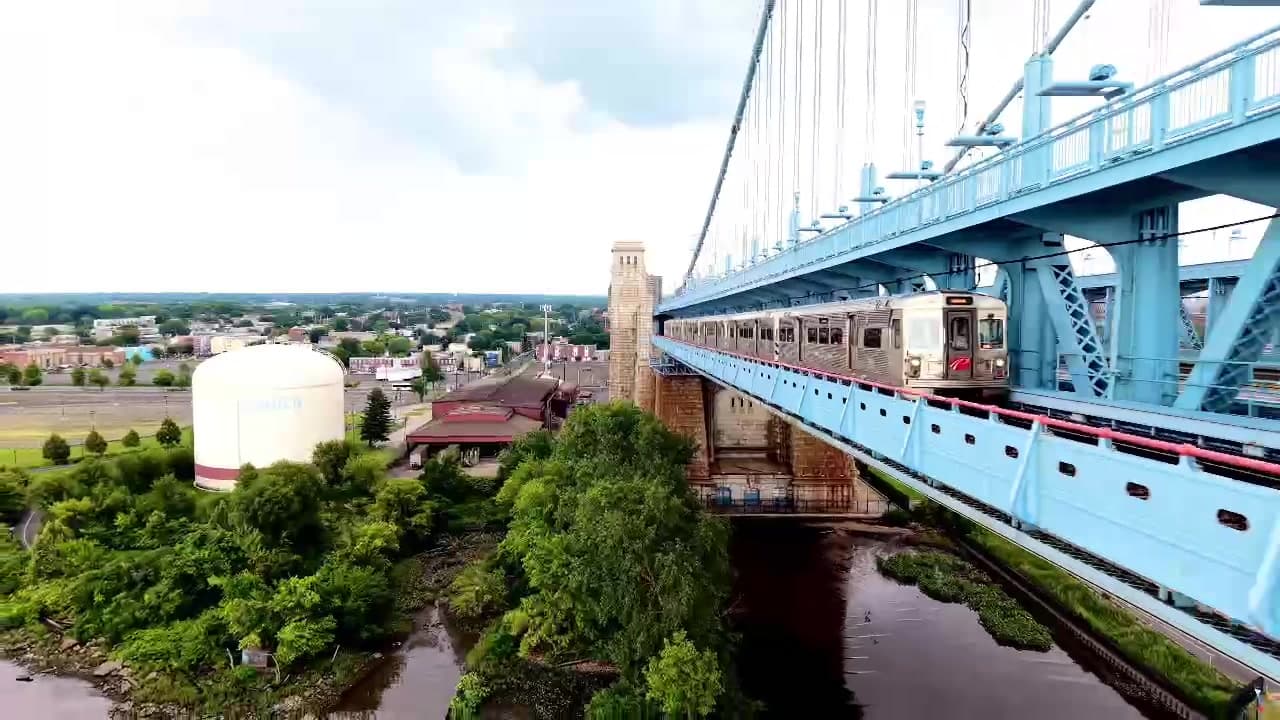 Aerial video frame following a large bridge crossing over water